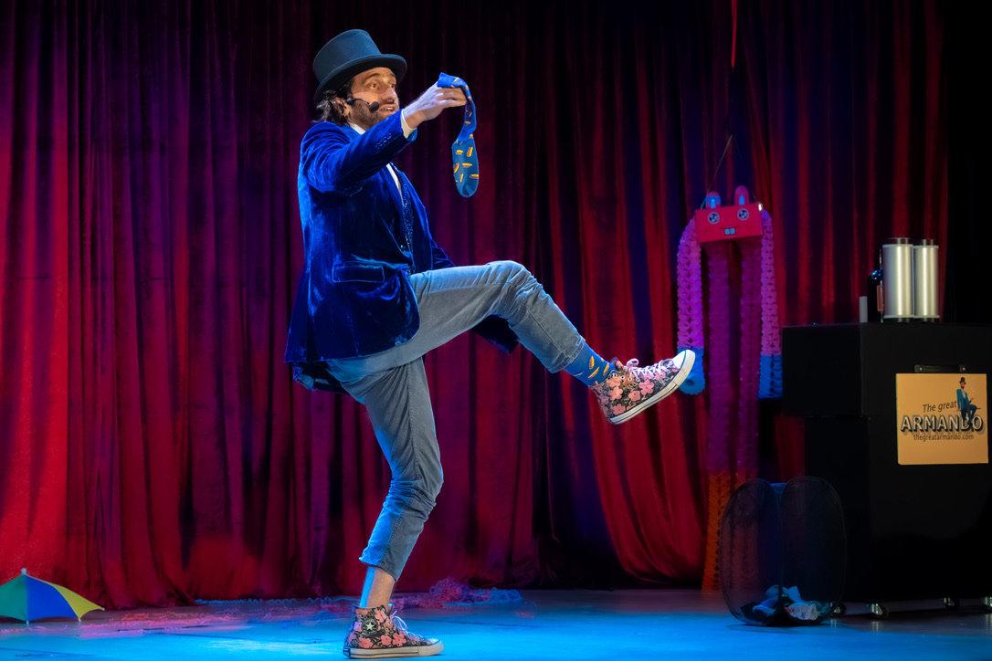 Armando holds one sock and one leg up