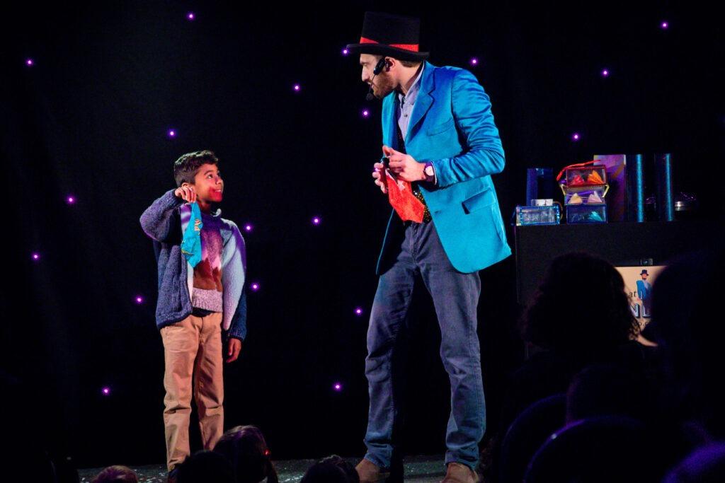 Armandoo and a child together on stage